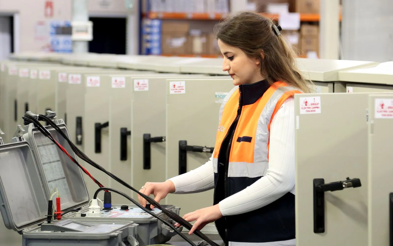 Technikerin prüft eine Schaltanlage